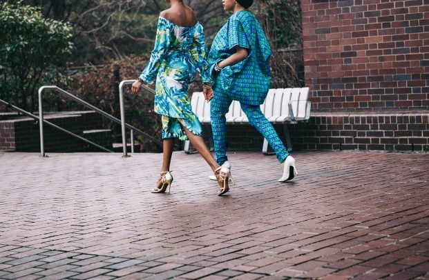 women in blue patterned clothing and heels walking