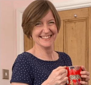 Catherine Hughes of Growing Family smiling and holding a mug
